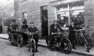 J W Coombs and Son cycle shop in North Road. L-R Sonny Coombs, unknown, Alec Tucker, Mrs Coombs, Percy Thatcher and Bill Coombs