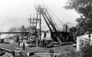 Picture of the pithead where the trucks have been loaded into the cage ready to be lowered for filling.