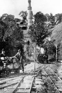 This is an early picture showing full trucks being lowered down the tramway to the Somersetshire Coal Canal. The tramway was laid in 1855-6 but not brought into use until 1859. Notice the chain between the tracks which was used to control the speed of the trucks.