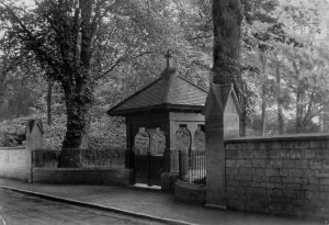The entrance to the cemetery in the Avenue. In 1898 the Lord Bishop of Bath and Wells consecrated an additional churchyard (the cemetery) for the village. The new burial ground which had been a gift by the Samborne's of Timsbury House.