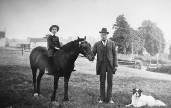 Elizabeth Hodder's husband, George, with grandson Edwin in fields below South Road.